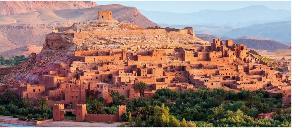 Image of the Kasbah of Ait Ben Haddou, an ancient fortified city in Morocco, with traditional Berber architecture and narrow alleys winding through the earthen clay buildings.