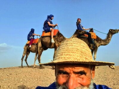 Tourists enjoying a scenic camel ride in Marrakech's desert. tour: Moroccan Lunch and Pool