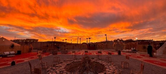 Lantern-lit Agafay Desert dinner and show camp at sunset
