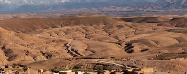 Wide-angle view of the Agafay Desert with distant Atlas Mountains
