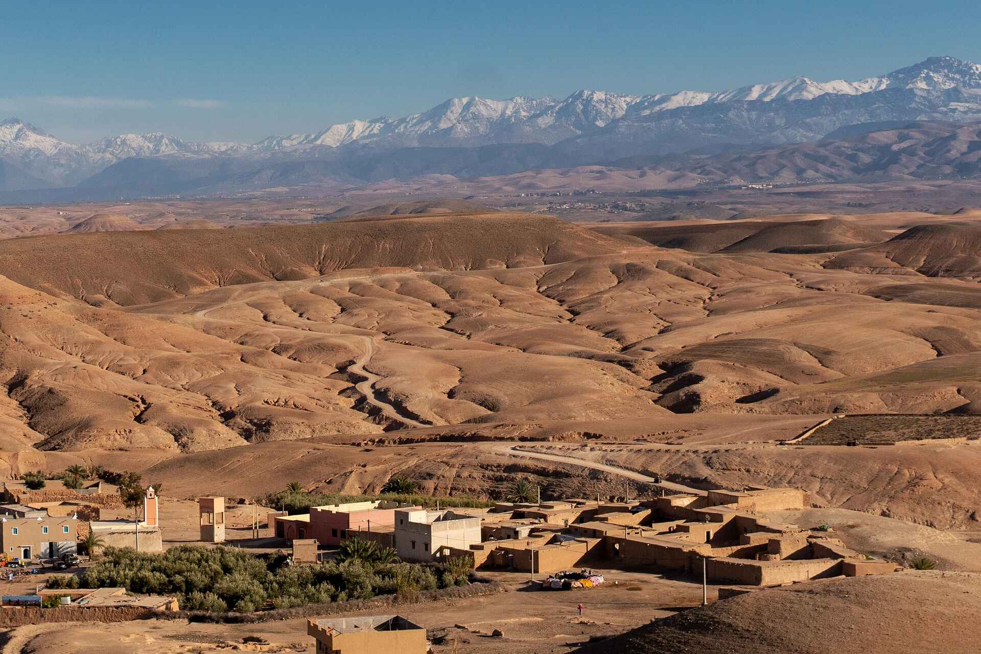 Wide-angle view of the Agafay Desert with distant Atlas Mountains